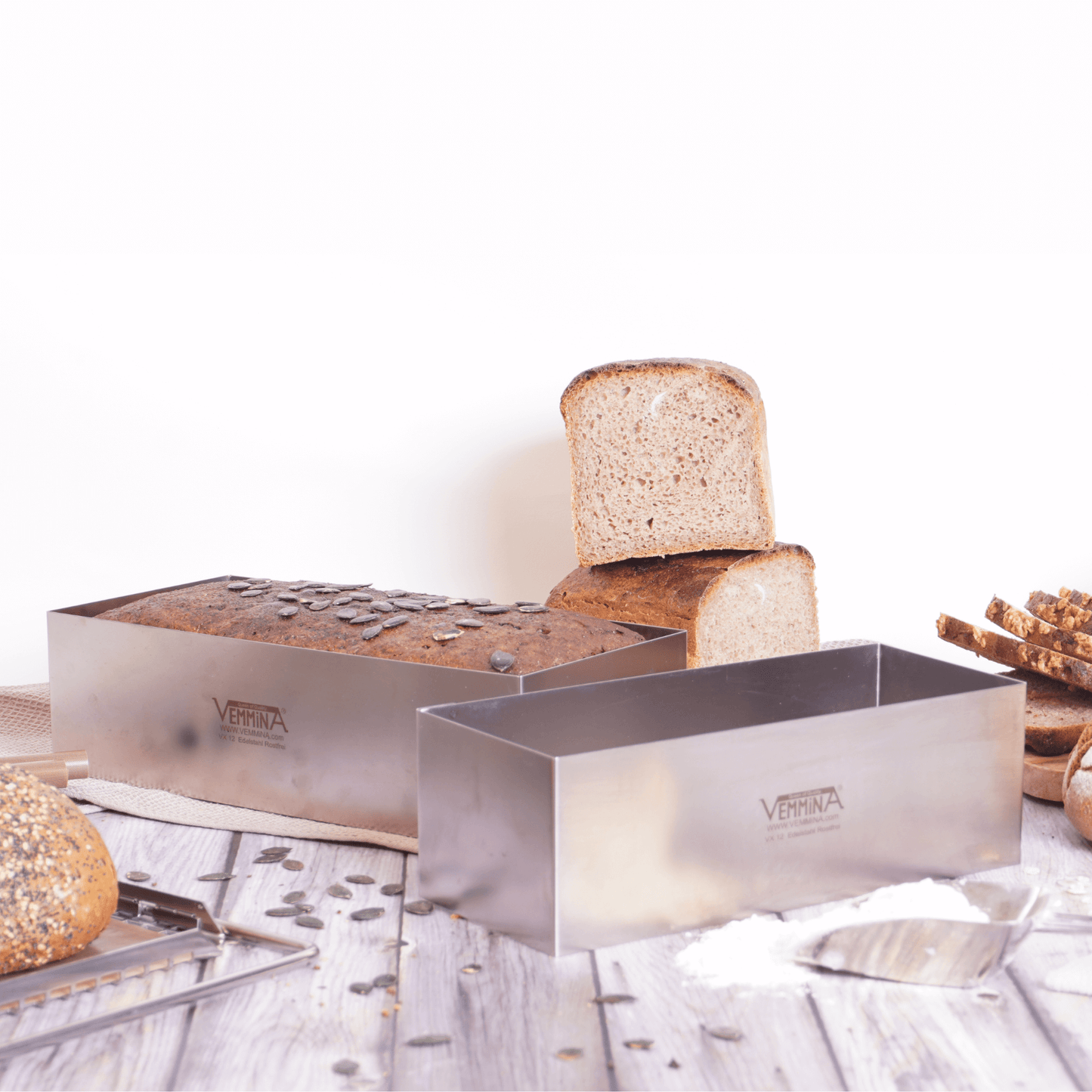 Stainless steel Brot-Profi bread mold with freshly baked loaves on a wooden table, perfect for homemade bread.